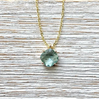Gold chain necklace with blue gemstone solitaire pendant
