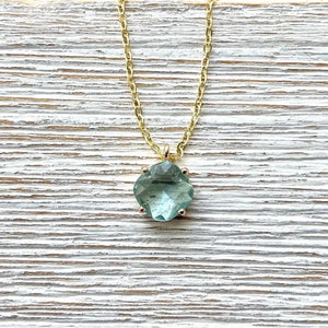 Gold chain necklace with blue gemstone solitaire pendant