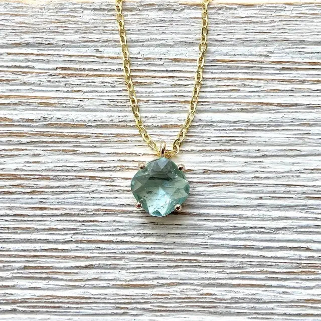Gold chain necklace with blue gemstone solitaire pendant