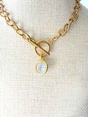 Gold chain choker necklace with toggle closure and large crystal pendant