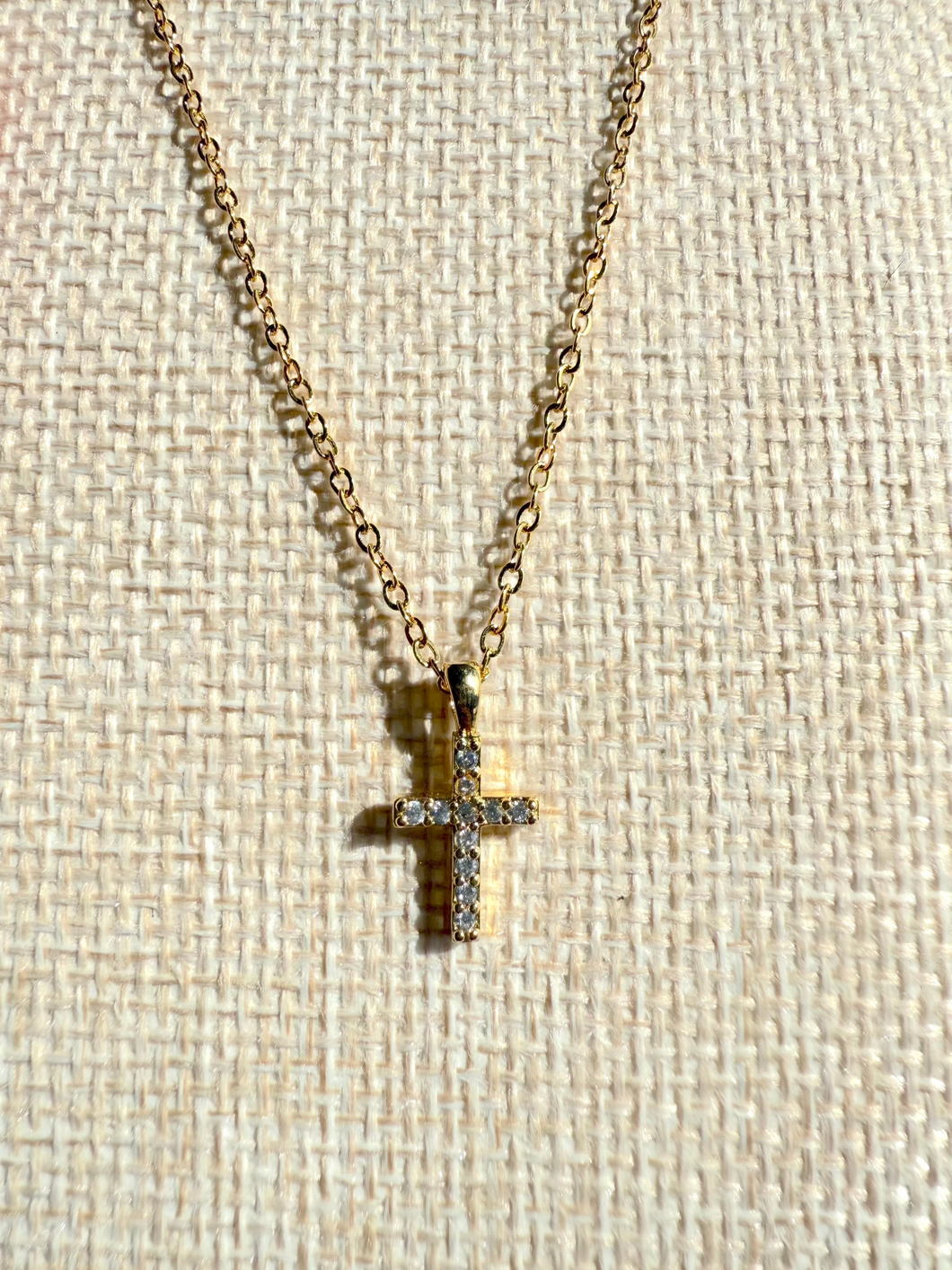 Gold cross necklace with cubic zirconia stones on chain