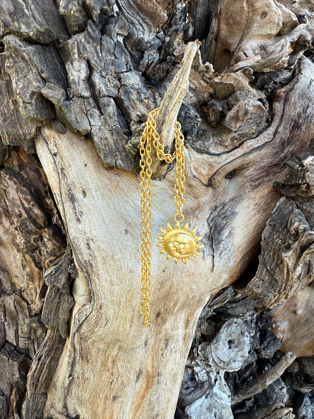 Gold-plated necklace with a sun face pendant on a chain necklace

