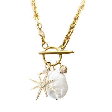 Gold toggle charm necklace with large pearl, star, and crystal bead.